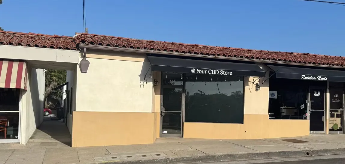 The storefront at 10-C West Calle Laureles Street, Santa Barbara — a tiled-roof retail row with a large display window under a black awning.
